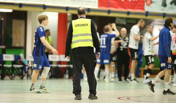 Handball, Saison 2025 2026, 3. Liga, Staffel Nord-Ost, Männer. HG Hamburg-Barmbek - EHV Aue. Ein Ordner steht nach dem Ende des Spiels auf dem Parkett und sondiert die Lage. Wandsbek Hamburg