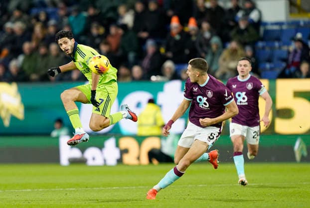 Burnley, England, 13th December 2025. Raul JimÃ nez of Fulham leaps up to knock the ball past Maxime Esteve of Burnley during the Burnley vs Fulham Premier League match at Turf Moor, Burnley. Picture credit should read: Andrew Yates Sportimage EDITORIAL USE ONLY. No use with unauthorised audio, video, data, fixture lists, club league logos or live services. Online in-match use limited to 120 images, no video emulation. No use in betting, games or single club league player publications. SPI_044_AY_Burnley_Fulham SPI-4374-0045