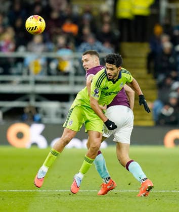 Burnley, England, 13th December 2025. Maxime Esteve of Burnley tussles with Raul JimÃ nez of Fulham during the Burnley vs Fulham Premier League match at Turf Moor, Burnley. Picture credit should read: Andrew Yates Sportimage EDITORIAL USE ONLY. No use with unauthorised audio, video, data, fixture lists, club league logos or live services. Online in-match use limited to 120 images, no video emulation. No use in betting, games or single club league player publications. SPI_055_AY_Burnley_Fulham SPI-4374-0055