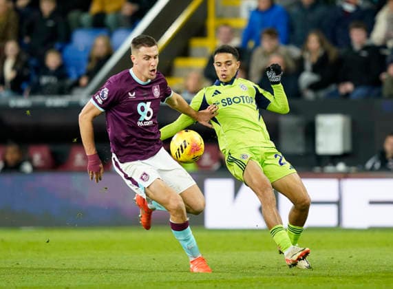 Burnley, England, 13th December 2025. Maxime Esteve of Burnley and Joshua King of Fulham during the Burnley vs Fulham Premier League match at Turf Moor, Burnley. Picture credit should read: Andrew Yates Sportimage EDITORIAL USE ONLY. No use with unauthorised audio, video, data, fixture lists, club league logos or live services. Online in-match use limited to 120 images, no video emulation. No use in betting, games or single club league player publications. SPI_056_AY_Burnley_Fulham SPI-4374-0056