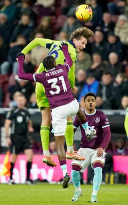 Burnley, England, 13th December 2025. Sander Berge of Fulham gets above Mike Tresor of Burnley during the Burnley vs Fulham Premier League match at Turf Moor, Burnley. Picture credit should read: Andrew Yates Sportimage EDITORIAL USE ONLY. No use with unauthorised audio, video, data, fixture lists, club league logos or live services. Online in-match use limited to 120 images, no video emulation. No use in betting, games or single club league player publications. SPI_057_AY_Burnley_Fulham SPI-4374-0058
