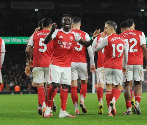 Football - 2025 2026 Premier League - Arsenal vs Weolverhampton Wanderers - Emirates Stadium - Saturday 13th December 2025. Bukayo Saka celebrates with Arsenal™s players after his cross led to the first goal 