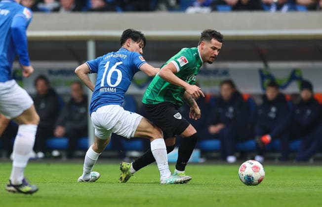14.12.2025, Fussball 2. Bundesliga, SV Darmstadt 98 - SC Preußen Münster, emonline, emspor, despor, v.l., Hiroki Akiyama (SV Darmstadt 98), Yassine Bouchama (SC Preußen Münster) DFL DFB REGULATIONS PROHIBIT ANY USE OF PHOTOGRAPHS AS IMAGE SEQUENCES AND OR QUASI-VIDEO. xdcx