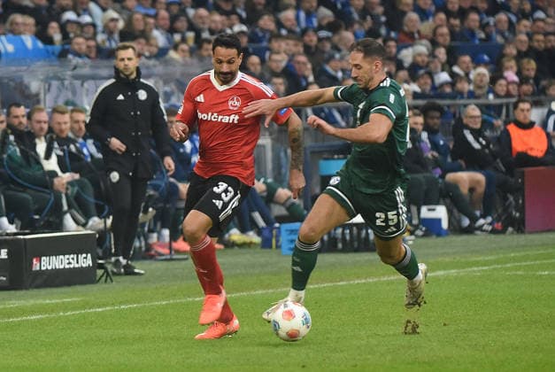 14.12.2025, xhbx, Fussball 2.Bundesliga, FC Schalke 04 - 1.FC Nürnberg v.l. Adriano Grimaldi (1.FC Nuernberg), Nikola Katic (FC Schalke 04) (DFL DFB REGULATIONS PROHIBIT ANY USE OF PHOTOGRAPHS as IMAGE SEQUENCES and or QUASI-VIDEO) Gelsenkirchen