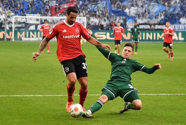 14.12.2025, xhbx, Fussball 2.Bundesliga, FC Schalke 04 - 1.FC Nürnberg v.l. Adriano Grimaldi (1.FC Nuernberg), Vitalie Becker (FC Schalke 04) (DFL DFB REGULATIONS PROHIBIT ANY USE OF PHOTOGRAPHS as IMAGE SEQUENCES and or QUASI-VIDEO) Gelsenkirchen