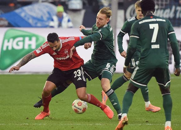14.12.2025, xhbx, Fussball 2.Bundesliga, FC Schalke 04 - 1.FC Nürnberg v.l. Adriano Grimaldi (1.FC Nuernberg), Timo Becker (FC Schalke 04) (DFL DFB REGULATIONS PROHIBIT ANY USE OF PHOTOGRAPHS as IMAGE SEQUENCES and or QUASI-VIDEO) Gelsenkirchen