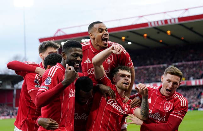 Nottingham, England, 14th December 2025. Callum Hudson-Odoi of Nottingham Forest is mobbed as he celebrates scoring their second goal with Murillo of Nottingham Forest jumping over the top during the Nottingham Forest vs Tottenham Hotspur Premier League match at the City Ground, Nottingham. Picture credit should read: Andrew Yates Sportimage EDITORIAL USE ONLY. No use with unauthorised audio, video, data, fixture lists, club league logos or live services. Online in-match use limited to 120 images, no video emulation. No use in betting, games or single club league player publications. SPI_058_AY_Forest_Spurs SPI-4376-0058