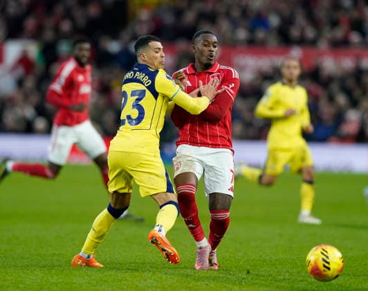 Nottingham, England, 14th December 2025. IPedro Porro of Tottenham challenges Callum Hudson-Odoi of Nottingham Forest during the Nottingham Forest vs Tottenham Hotspur Premier League match at the City Ground, Nottingham. Picture credit should read: Andrew Yates Sportimage EDITORIAL USE ONLY. No use with unauthorised audio, video, data, fixture lists, club league logos or live services. Online in-match use limited to 120 images, no video emulation. No use in betting, games or single club league player publications. SPI_081_AY_Forest_Spurs SPI-4376-0081