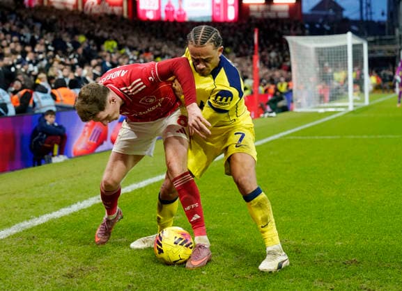 Nottingham, England, 14th December 2025. Elliot Anderson of Nottingham Forest tussles with Xavi Simons of Tottenham during the Nottingham Forest vs Tottenham Hotspur Premier League match at the City Ground, Nottingham. Picture credit should read: Andrew Yates Sportimage EDITORIAL USE ONLY. No use with unauthorised audio, video, data, fixture lists, club league logos or live services. Online in-match use limited to 120 images, no video emulation. No use in betting, games or single club league player publications. SPI_083_AY_Forest_Spurs SPI-4376-0083