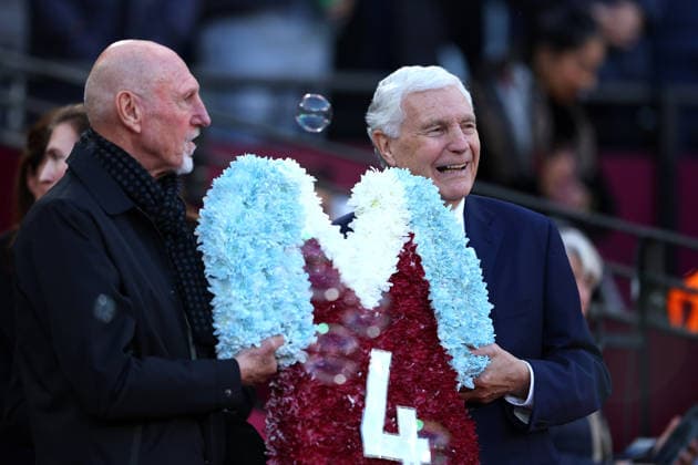 14th December 2025; London Stadium, London, England; Premier League Football, West Ham United versus Aston Villa; Former West Ham United player Trevor Brooking and Alvin Martin holding a Number 4 wreath during the Billy Bonds tribute before kick off  JohnxPatrickxFletcher