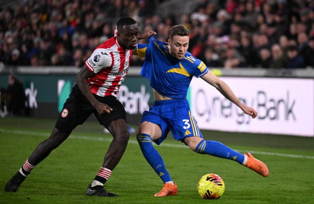 14th December 2025; Gtech Community Stadium, Brentford, London, England; Premier League Football, Brentford versus Leeds United; Gabriel Gudmundsson of Leeds United crosses under pressure from Michael Kayode of Brentford  SimonxWest