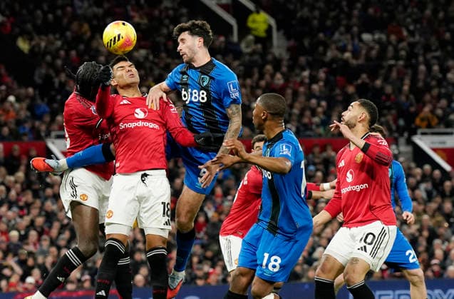 Manchester, England, 15th December 2025. Leny Yoro and Casemiro of Manchester United, ManU tussles with Evanilson of Bournemouth during the Manchester United vs AFC Bournemouth Premier League match at Old Trafford, Manchester. Picture credit should read: Andrew Yates Sportimage EDITORIAL USE ONLY. No use with unauthorised audio, video, data, fixture lists, club league logos or live services. Online in-match use limited to 120 images, no video emulation. No use in betting, games or single club league player publications. SPI_025_AY_Man_Utd_Bmouth SPI-4379-0025