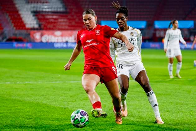 Lynn Groenewegen of FC Twente dribbles with the ball under pressure from Naomie Feller of Real Madrid FC Twente v Real Madrid CF, UEFA Women s Champions League 2025 26 League Phase MD6, FC Twente v Real Madrid CF, FC Twente Stadium, December 17, 2025, Enschede, Netherlands.