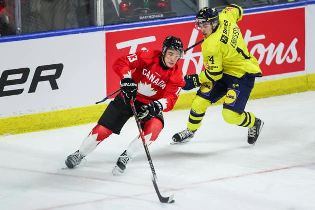 December 17, 2025, Kitchener, On, Canada: Canada s Ethan Mackenzie (13) carries the puck past Sweden s Linus Eriksson (14) during first period IIHF World Junior Hockey Championship pre-tournament action in Kitchener, Ont. on Wednesday, December 17, 2025. Canada News - December 17, 2025  - ZUMAc35_ 20251217_zaf_c35_038 Copyright: xNickxIwanyshynx