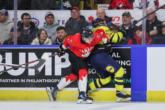 December 17, 2025, Kitchener, On, Canada: Canada s Ethan Mackenzie (13) hits Sweden s Casper Juustovaara Karlsson (29) during third period IIHF World Junior Hockey Championship pre-tournament action in Kitchener, Ont. on Wednesday, December 17, 2025. Canada News - December 17, 2025  - ZUMAc35_ 20251217_zaf_c35_052 Copyright: xNickxIwanyshynx