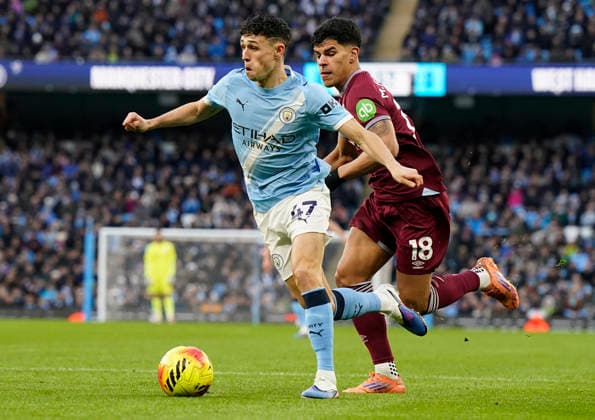 Manchester, England, 20th December 2025. Phil Foden of Manchester City (L) is challenged by Mateus Fernandes of West Ham United during the Manchester City vs West Ham United Premier League match at the Etihad Stadium, Manchester. Picture credit should read: Andrew Yates Sportimage EDITORIAL USE ONLY. No use with unauthorised audio, video, data, fixture lists, club league logos or live services. Online in-match use limited to 120 images, no video emulation. No use in betting, games or single club league player publications. SPI_022_AY_MAN_CITY_WEST_HAM SPI-4385-0022