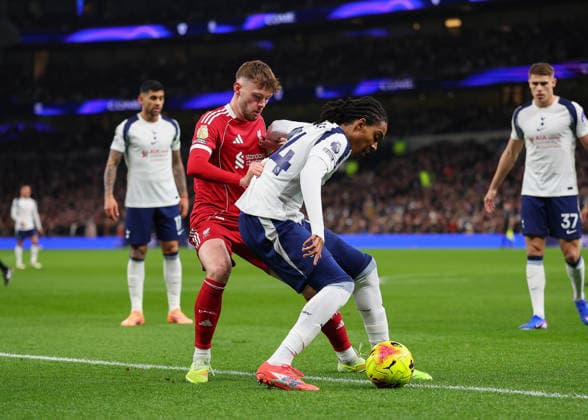 20th December 2025; Tottenham Hotspur Stadium, London, England; Premier League Football, Tottenham Hotspur versus Liverpool; Djed Spence of Tottenham Hotspur challenged by Conor Bradley of Liverpool  JohnxPatrickxFletcher