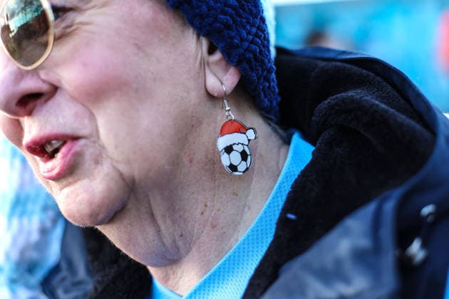 Man City v West Ham 20th December 2025, Manchester - Premier League Football - Manchester City v West Ham United - A Manchester City fan with Christmas football earrings - Photo: Charlotte Wilson Offside. Manchester UK Copyright: xCharlottexWilsonx xOffsidexOffside