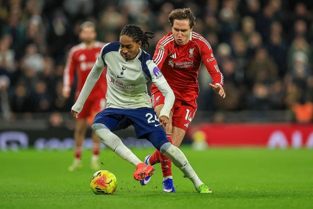 Tottenham Hotspur v Liverpool Premier League 20 12 2025. Tottenham Hotspur Defender Djed Spence (24) under Pressure from Liverpool Forward Federico Chiesa (14) during the Premier League match between Tottenham Hotspur and Liverpool at Tottenham Hotspur Stadium, London, United Kingdom on 20 December 2025. Editorial use only DataCo restrictions apply See www.football-dataco.com , Copyright: xChrisxFoxwellx PSI-23445-0130