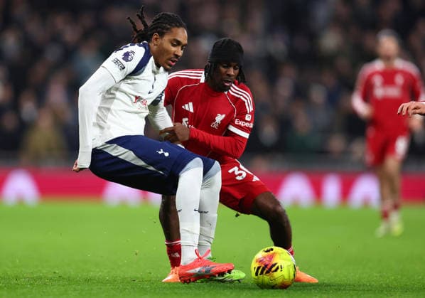 London, England, 20th December 2025. Djed Spence of Tottenham Hotspur and Jeremie Frimpong of Liverpool challenge for the ball during the Tottenham Hotspur vs Liverpool Premier League match at the Tottenham Hotspur Stadium, London. Picture credit should read: Paul Terry Sportimage EDITORIAL USE ONLY. No use with unauthorised audio, video, data, fixture lists, club league logos or live services. Online in-match use limited to 120 images, no video emulation. No use in betting, games or single club league player publications. SPI_057_PT_Tottenham_Liverpool SPI-4387-0057
