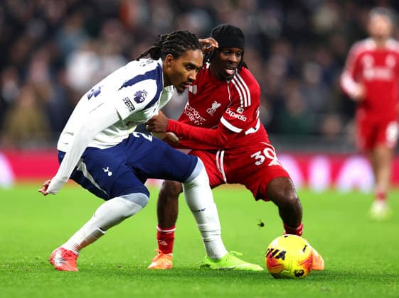London, England, 20th December 2025. Djed Spence of Tottenham Hotspur and Jeremie Frimpong of Liverpool challenge for the ball during the Tottenham Hotspur vs Liverpool Premier League match at the Tottenham Hotspur Stadium, London. Picture credit should read: Paul Terry Sportimage EDITORIAL USE ONLY. No use with unauthorised audio, video, data, fixture lists, club league logos or live services. Online in-match use limited to 120 images, no video emulation. No use in betting, games or single club league player publications. SPI_058_PT_Tottenham_Liverpool SPI-4387-0058