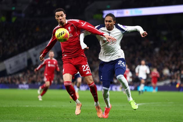 London, England, 20th December 2025. Hugo Ekitike of Liverpool and Djed Spence of Tottenham Hotspur challenge for the ball during the Tottenham Hotspur vs Liverpool Premier League match at the Tottenham Hotspur Stadium, London. Picture credit should read: Paul Terry Sportimage EDITORIAL USE ONLY. No use with unauthorised audio, video, data, fixture lists, club league logos or live services. Online in-match use limited to 120 images, no video emulation. No use in betting, games or single club league player publications. SPI_067_PT_Tottenham_Liverpool SPI-4387-0067
