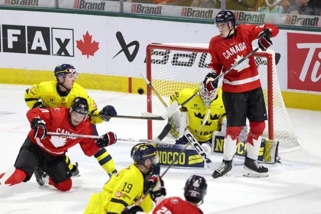 December 20, 2025, London, On, Canada: Canada forward Porter Martone (right) tries to tip a shot in front of Sweden goaltender Love Harenstam (30) during the third period of a IIHF World Junior Hockey Championship pre-tournament game in London, Ont., Saturday, December 20, 2025. Canada News - December 20, 2025  - ZUMAc35_ 20251220_zaf_c35_092 Copyright: xNicolexOsbornex