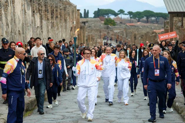 Sport Themen der Woche KW52 Pompei: December 22, 2025, Milan-Cortina 2026 Winter Olympics. The photo shows the Olympic torch passing through the Archaeological Park. Actor Jackie Chan  Copyright: xAlessandroxGarofalo LaPressex