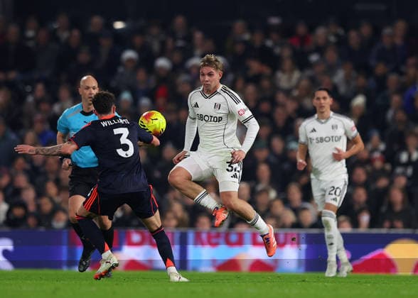 22nd December 2025; Craven Cottage, Fulham, London, England; Premier League Football, Fulham versus Nottingham Forest; Emile Smith Rowe of Fulham chips the ball over Neco Williams of Nottingham Forest  JohnxPatrickxFletcher