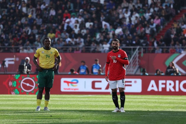 AGADIR, MOROCCO - December 26, 2025 - Mbekezeli Mbokazi of South Africa National football team and Mohamed Salah of Egypt national team, Nationalteam full lenght in home kit during the match between Egypt national team and South Africa national team in football at Africa Cup of Nations 2025 in Ardar Stadium in Agadir, Morocco AFCON 2025 - Egypt v South Africa national soccer team - Group B Copyright: xSFSI SebastianxFrejx