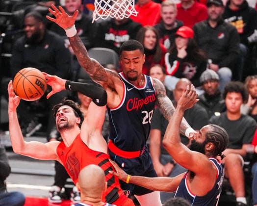 (251227) -- PORTLAND, Dec. 27, 2025 -- John Collins (top) of Los Angeles Clippers defends Deni Avdija (L) of Portland Trail Blazers during the 2025-2026 NBA, Basketball Herren, USA regular season match between Portland Trail Blazers and Los Angeles Clippers in Portland, the United States, Dec. 26, 2025. (Photo by Xinhua) (SP)U.S.-PORTLAND-BASKETBALL-NBA-CLIPPERS VS BLAZERS SunxYuxuan 