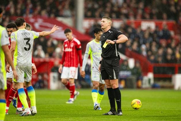 27th December 2025; The City Ground, Nottingham, England; Premier League Football, Nottingham Forest versus Manchester City; Referee Robert Jones issues a yellow card to Ruben Dias of Manchester City  GodfreyxPitt