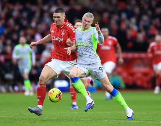 Nottingham, England, 27th December 2025. Nikola Milenkovic of Nottingham Forest tussles with Erling Haaland of Manchester City during the Nottingham Forest vs Manchester City Premier League match at the City Ground, Nottingham. Picture credit should read: Jessica Hornby Sportimage EDITORIAL USE ONLY. No use with unauthorised audio, video, data, fixture lists, club league logos or live services. Online in-match use limited to 120 images, no video emulation. No use in betting, games or single club league player publications. SPI_067_JH_Forest_ManC SPI-4395-0069