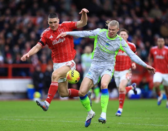 Nottingham, England, 27th December 2025. Nikola Milenkovic of Nottingham Forest tussles with Erling Haaland of Manchester City during the Nottingham Forest vs Manchester City Premier League match at the City Ground, Nottingham. Picture credit should read: Jessica Hornby Sportimage EDITORIAL USE ONLY. No use with unauthorised audio, video, data, fixture lists, club league logos or live services. Online in-match use limited to 120 images, no video emulation. No use in betting, games or single club league player publications. SPI_068_JH_Forest_ManC SPI-4395-0070