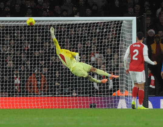 Football - 2025 2026 Premier League - Arsenal vs Brighton & Hove Albion - Emirates Stadium - Saturday 27th December 2025 Goalkeeper, David Raya of Arsenal makes a finger tip save 