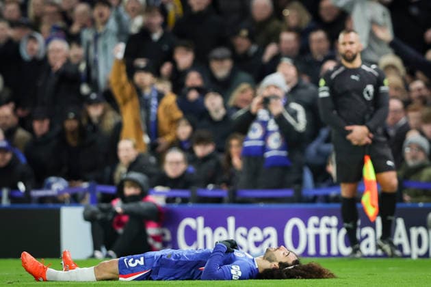 27th December 2025; Stamford Bridge, Chelsea, London, England: Premier League Football, Chelsea versus Aston Villa; Marc Cucurella of Chelsea on the ground, watched by assistant referee Constantine Hatzidakis  IanxStephen