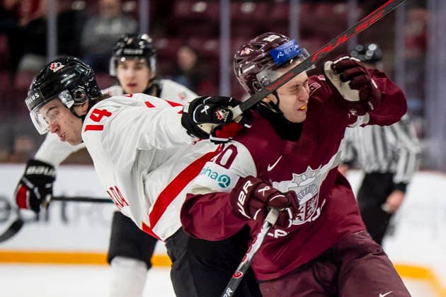 December 27, 2025, Minneapolis, Mn, Canada: Canada s Ben Danford (14) hits Latvia s Kristians Utnans (20) with a stick during second period IIHF World Junior Championship hockey action, in Minneapolis, Saturday, Dec. 27, 2025. HKO-World-Juniors-Canada-Latvia 20251227  - ZUMAc35_ 20251227_zaf_c35_090 Copyright: xChristopherxKatsarovx