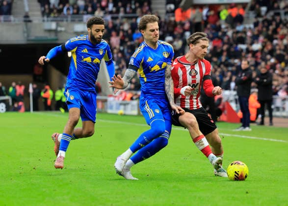 Sunderland v Leeds United Premier League Dennis Cirkin of Sunderland (right) shields the ball from Joe Rodon of Leeds United and Jayden Bogle of Leeds United (left) during the Premier League match at the Stadium of Light, Sunderland 28 12 2025 UK Newspapers OUT Copyright: xFredxPalmerx FIL-22706-0229