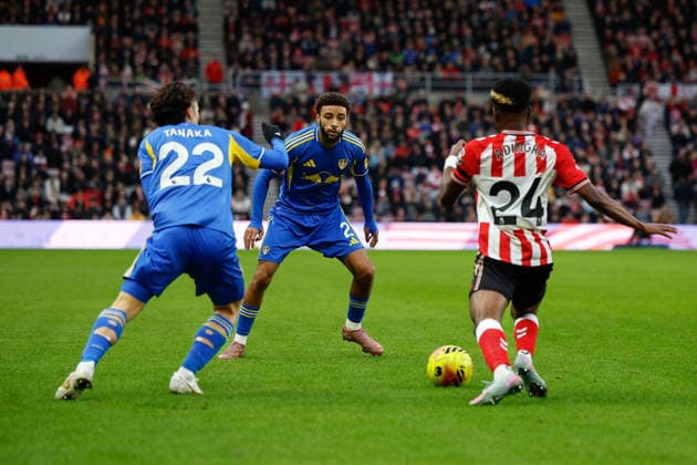 Sunderland v Leeds United, Premier League Jayden Bogle and Ao Tanaka of Leeds United close down Simon Adingra of Sunderland during the Premier League match between Sunderland and Leeds United at the Stadium Of Light, Sunderland, UK on 28 December 2025. Sunderland Stadium Of Light Tyne and Wear UK Editorial use only DataCo restrictions apply See www.football-dataco.com , Copyright: xCraigxCowanx PSI-23476-0096