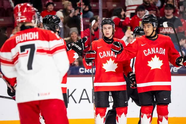 December 29, 2025, Minneapolis, Minn., Mn, Canada: Canada s Zayne Parekh (19) celebrates his goal with teammates Gavin McKenna (9) and Cole Reschny (21) after scoring during first period IIHF World Junior Championship hockey action against Denmark in Minneapolis on Monday, Dec. 29, 2025. Canada News - December 29, 2025  - ZUMAc35_ 20251229_zaf_c35_051 Copyright: xChristopherxKatsarovx