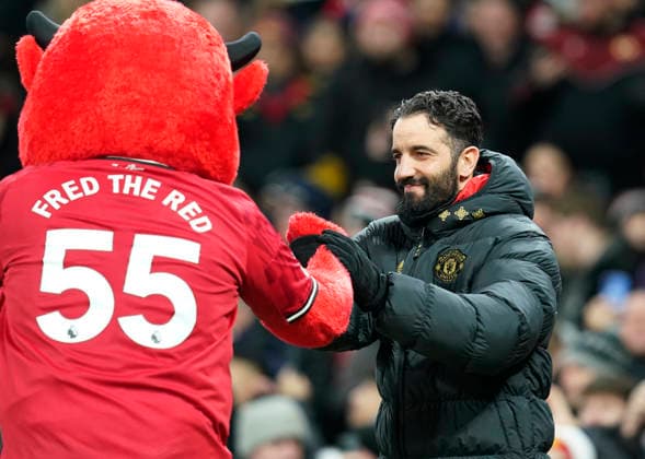 Manchester, England, 30th December 2025. Fred the Red the club mascot greets Ruben Amorim manager of Manchester United, ManU (r) during the Manchester United vs Wolverhampton Wanderers Premier League match at Old Trafford, Manchester. Picture credit should read: Andrew Yates Sportimage EDITORIAL USE ONLY. No use with unauthorised audio, video, data, fixture lists, club league logos or live services. Online in-match use limited to 120 images, no video emulation. No use in betting, games or single club league player publications. SPI_029_AY_Man_Utd_Wolves SPI-4404-0030