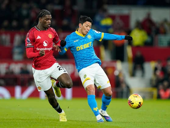 Manchester, England, 30th December 2025. Ayden Heaven of Manchester United, ManU (l) tackles Hee Chan Hwang of Wolverhampton Wanderers (r) during the Manchester United vs Wolverhampton Wanderers Premier League match at Old Trafford, Manchester. Picture credit should read: Andrew Yates Sportimage EDITORIAL USE ONLY. No use with unauthorised audio, video, data, fixture lists, club league logos or live services. Online in-match use limited to 120 images, no video emulation. No use in betting, games or single club league player publications. SPI_031_AY_Man_Utd_Wolves SPI-4404-0033