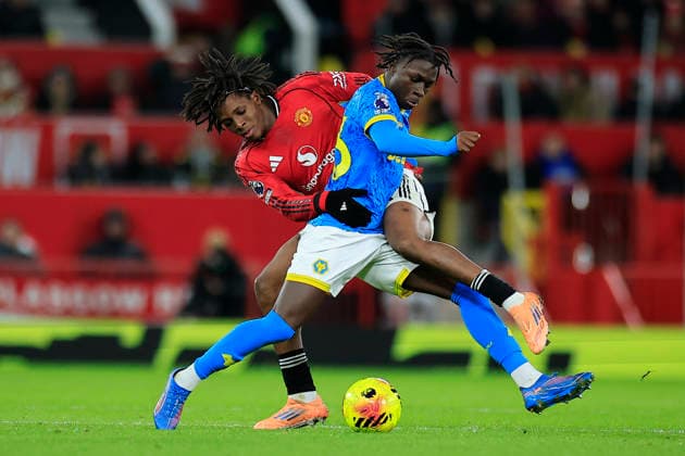 Manchester United, ManU v Wolverhampton Wanderers, Premier League Patrick Dorgu (13) of Manchester United and Mateus Mane (36) of Wolverhampton Wanderers challenge for the ball during the Premier League match between Manchester United and Wolverhampton Wanderers at Old Trafford, Manchester, UK on 30 December 2025. Manchester Old Trafford Greater Manchester UK Editorial use only DataCo restrictions apply See www.football-dataco.com , Copyright: xConorxMolloyx PSI-23486-0070