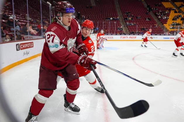 December 30, 2025, Minneapolis, Minnesota, United States: Latvia forward MARKUSS SIERADZKIS (27) and Denmark forward LASSE BAERENTSEN (23) connect in the corner. Latvia and Denmark faced off in the opening round of the IIHF World Junior Championship on December 30th. Latvia was victorious winning 6-3. Minneapolis United States - ZUMAt166 20251230_zsp_t166_021 Copyright: xMichaelxTurnerx
