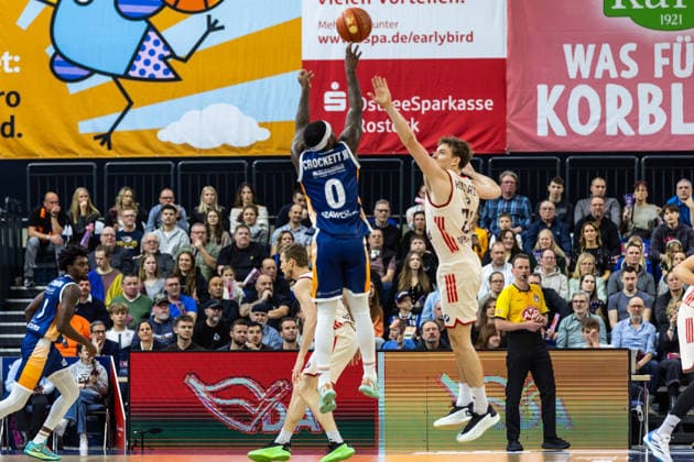 GER, easy-Credit Basketball-Bundesliga, Rostock Seawolves - FC Bayern München Basketball. 31.12.2025, Stadthalle, Rostock, GER, easy-Credit Basketball-Bundesliga, Rostock Seawolves - FC Bayern München Basketball. TJ Crockett Jr. (Rostock Seawolves 0), Justus Hollatz (FC Bayern München Basketball 21) Foto Alexander Trienitz Rostock Stadthalle Mecklenburg-Vorpommern Deutschland