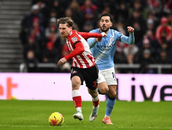 Dennis Cirkin of Sunderland fends off Rayan Cherki of Manchester City Sunderland v Manchester City, Premier League, Football, Stadium of Light, Sunderland, UK - 01 Jan 2026Sunderland Stadium of Light United Kingdom EDITORIAL USE ONLY No use with unauthorised audio, video, data, fixture lists, club league logos or live services. Online in-match use limited to 120 images, no video emulation. No use in betting, games or single club league player publications.  Copyright: xRichardxLee Shutterstockx 16216366r