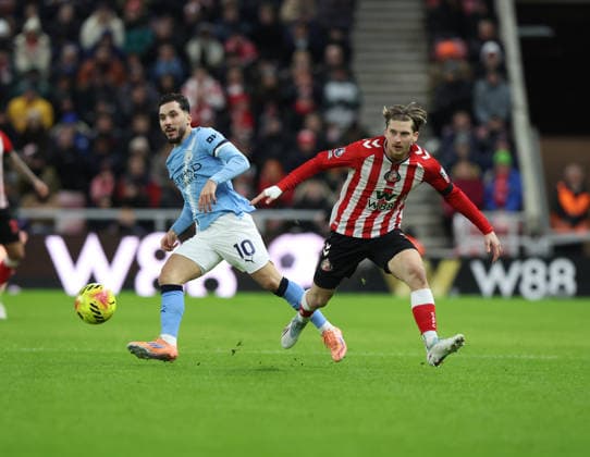Sunderland, England, 1st January 2026. Dennis Cirkin (R) of Sunderland in action with Rayan Chirki of Manchester City during the Sunderland vs Manchester City Premier League match at the Stadium Of Light, Sunderland. Picture credit should read: Nigel Roddis Sportimage EDITORIAL USE ONLY. No use with unauthorised audio, video, data, fixture lists, club league logos or live services. Online in-match use limited to 120 images, no video emulation. No use in betting, games or single club league player publications. SPI_015_NR_SUND_MANC SPI-4424-0015