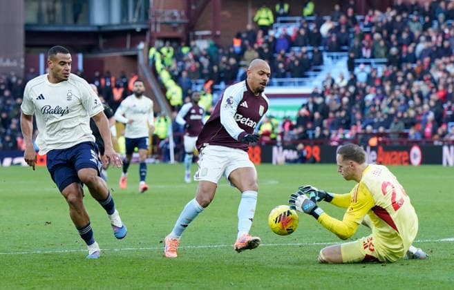 Birmingham, England, 3rd January 2026. Matz Sels of Nottingham Forest saves in front of the oncoming Donyell Malen of Aston Villa during the Aston Villa vs Nottingham Forest Premier League match at Villa Park, Birmingham. Picture credit should read: Andrew Yates Sportimage EDITORIAL USE ONLY. No use with unauthorised audio, video, data, fixture lists, club league logos or live services. Online in-match use limited to 120 images, no video emulation. No use in betting, games or single club league player publications. SPI_056_AY_Villa_Forest SPI-4426-0056