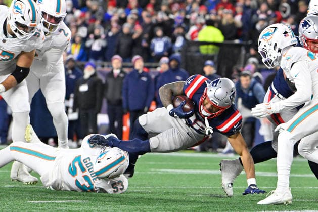 Jan 4, 2026; Foxboro, Massachusetts, USA; New England Patriots running back Treveyon Henderson (32) is tackled by Miami Dolphins linebacker Cameron Goode (53) during the first half at Gillette Stadium, in Foxborough, Massachusetts. CSM Foxborough USA - ZUMAc04_ 20260104_faf_c04_010 Copyright: xEricxCanhax