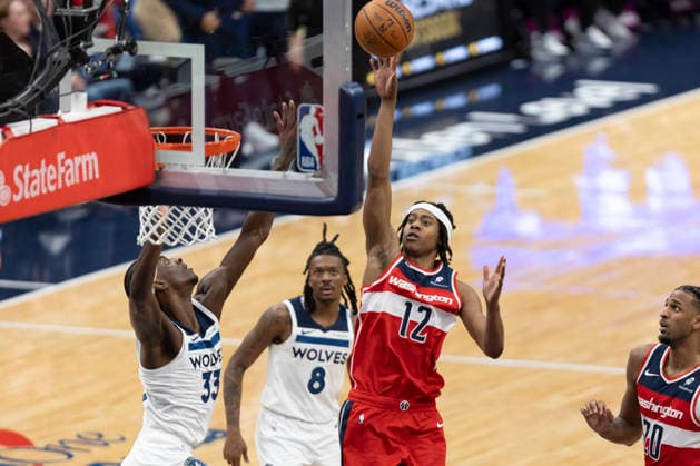 WASHINGTON, DC - JANUARY 04: Washington Wizards guard Tre Johnson (12) floats the ball over Minnesota Timberwolves forward Leonard Miller (33) during a game between Minnesota Timberwolves and Washington Wizards on January 4, 2026 at the Capital One Arena in Washington, DC. (Photo by Charles Brock Icon Sportswire) NBA, Basketball Herren, USA JAN 04 Minnesota Timberwolves at Washington Wizards EDITORIAL USE ONLY Icon260104032